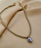 Featuring a bold, architectural rope chain, this piece serves as the perfect pedestal for a single, magnificent AAA-grade grey baroque pearl.