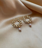 Close-up detail of AAA quality oval champagne freshwater pearl attached to PVD 18k gold plated stainless steel hardware. High-lustre pearl jewelry texture