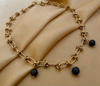 Parisian-chic gold statement necklace with black pearls