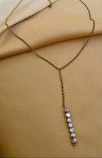 delicate gold Y-necklace featuring a vertical drop of six lustrous grey baroque pearls