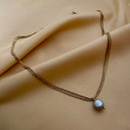 Grey baroque pearl necklace on layered gold chains