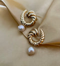Side view of Miranda gold twist hoops showing the organic shape of the baroque pearl drop. Water-resistant and hypoallergenic design