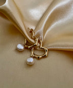 Jewelry styling inspiration featuring melted gold texture earrings with pearls. Minimalist bridal jewelry and statement gold hoops for a clean, elegant aesthetic