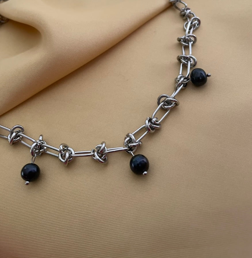 silver knotted link chain necklace featuring three round black pearl charms