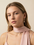 Side profile of a model showcasing the scale and fit of gold U-link pink pearl earrings against smooth skin